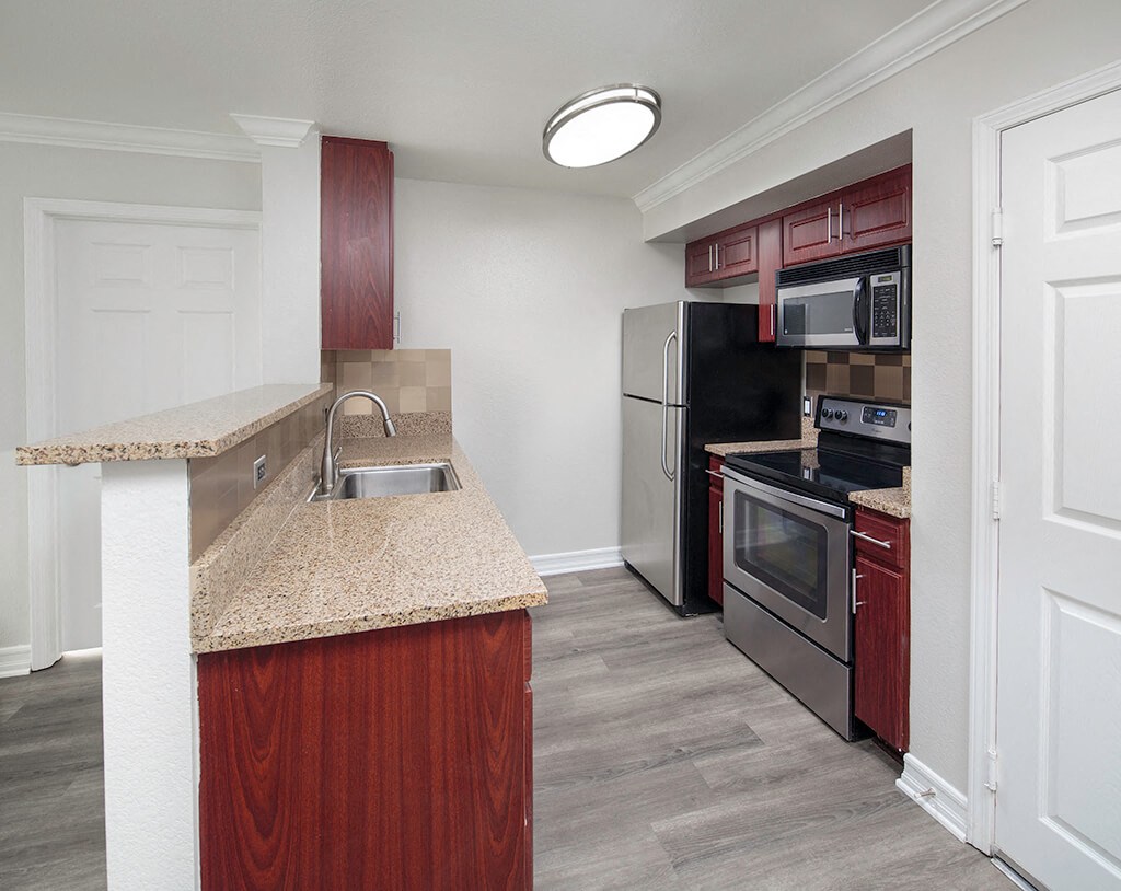 A bright kitchen with dark cabinets at the Il Palazzo in San Diego, California.